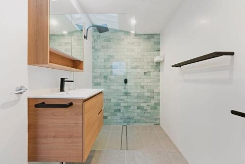 a bathroom with a sink and a shower at Cosy Camperdown in Sydney