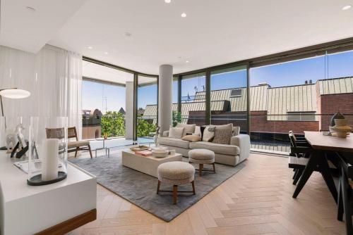 a living room with a couch and a piano at Terrace Boutique in the Heart of The Rocks in Sydney