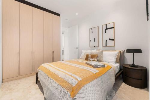 a bedroom with a large bed and a cabinet at Terrace Boutique in the Heart of The Rocks in Sydney
