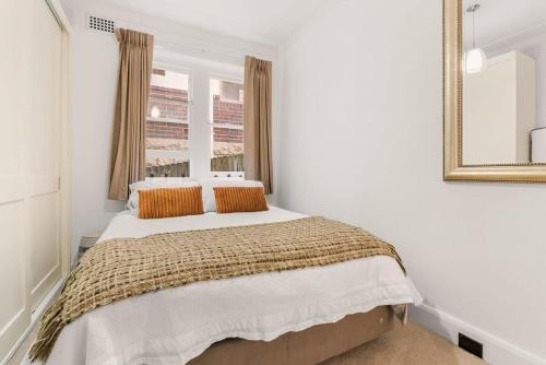 a bedroom with a large bed with a mirror at Classic Art Deco in Sydney