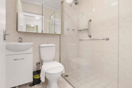 a bathroom with a toilet and a sink and a shower at Harbourside #15 in Sydney