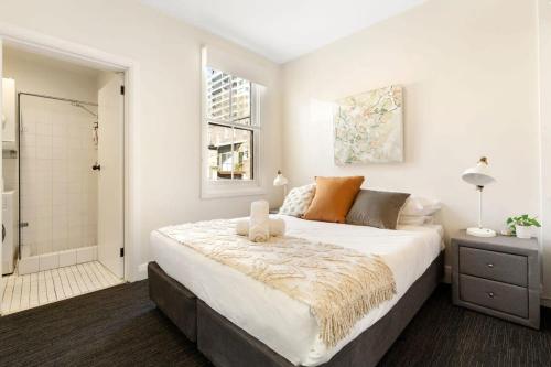 a bedroom with a large bed and a shower at Top Floor Apartment with Harbour Views in Sydney