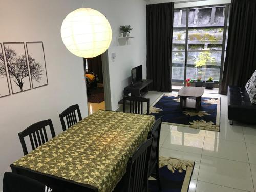 a dining room with a table and chairs and a lamp at Palas Horizon Mist in Cameron Highlands