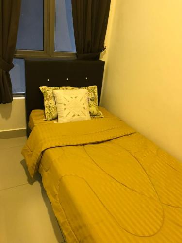 a yellow bed in a room with a window at Palas Horizon Mist in Cameron Highlands