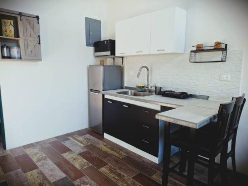 a kitchen with a sink and a counter top at Casa de las Brujas Escazú in Escazu