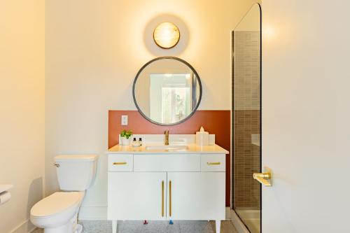 a bathroom with a white toilet and a mirror at Outrider 103 by AvantStay 2miles to DT Nash in Nashville