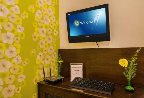 a computer monitor on top of a desk with a keyboard at Home@F37 Kailash Colony Metro in New Delhi
