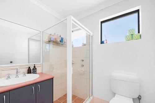 a bathroom with a toilet and a sink and a shower at House in Ellenbrook in The Vines