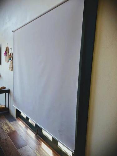 a large white screen on the side of a wall at Casa de las Brujas Escazú in Escazu