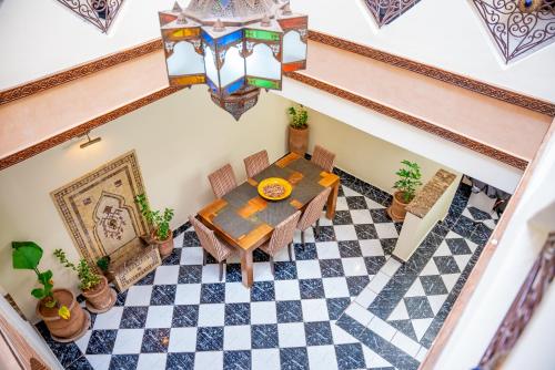 an overhead view of a dining room with a table and checkered floor at Riad The Moroccans Pool And Terrace in Marrakech