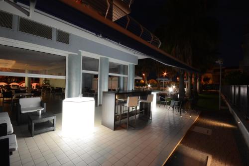 a patio with a table and chairs at night at Kiara Residence in Giulianova