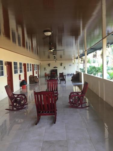 a lobby with chairs and tables in a building at The captains iin in Chinandega