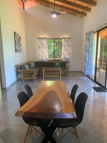 a living room with a wooden table and chairs at Casa Tres Tucanes in San Isidro
