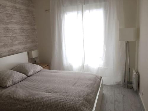 Schlafzimmer mit einem Bett und einem Fenster in der Unterkunft DISNEYLAND Paris (5 min from the park) in Chessy