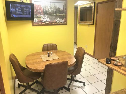 a dining room with a wooden table and chairs at West Main Lodge, 2 Bedrooom in Lead