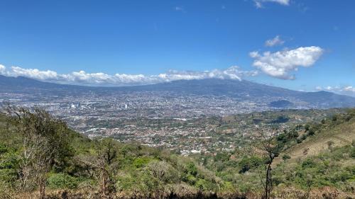 a view of a city from a mountain at Casa de las Brujas Escazú in Escazu