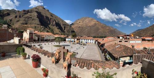 a view of a town with mountains in the background at shanti pisac in Pisac