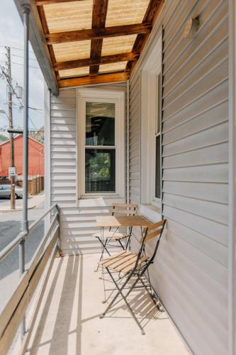 a patio with a table and chairs on the side of a house at Getaway on Grant heart of Downtown with parking in Lancaster