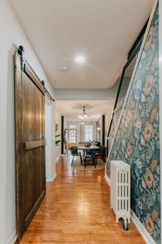 a hallway with a wooden door and a dining room at Comfy renovated townhome - heart of Downtown Lancaster in Lancaster