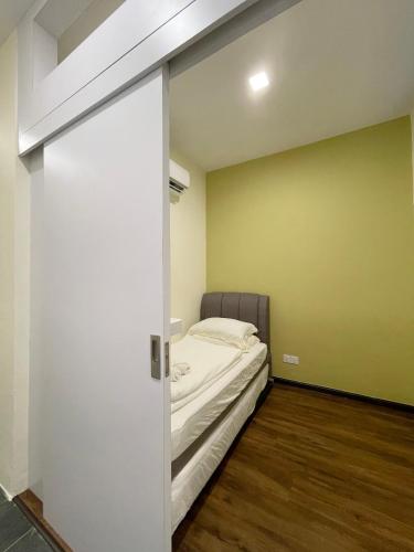 a room with a bed and a sliding door at Roxy Sematan Beach Townhouse Deluxe , 1 & 2 in Sematan