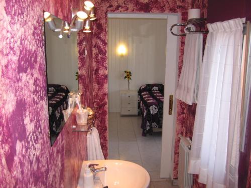 a bathroom with a sink and a mirror at Hospedaje Luciano in Suances