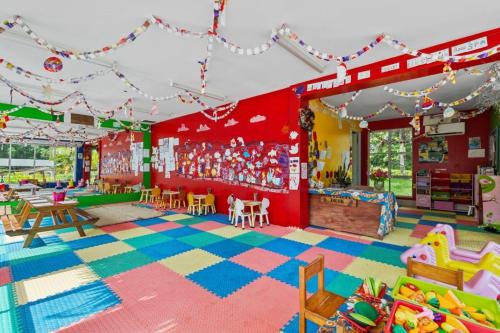 a room with a play area with toys and tables at Iririki Island Resort & Spa in Port Vila