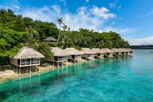 an island with overwater bungalows on the water at Iririki Island Resort & Spa in Port Vila