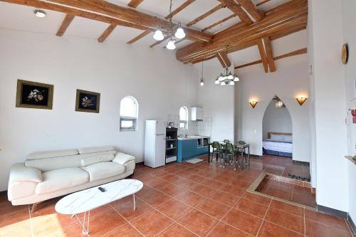 a living room with a couch and a table at Sweet Stay Pension in Seogwipo