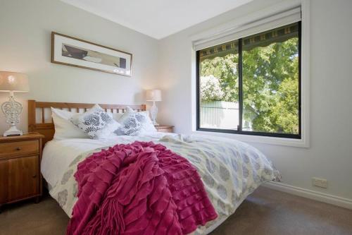 a bedroom with a large bed with a large window at Adelaide Hills 4 bed home near Hahndorf Mt Barker in Nairne