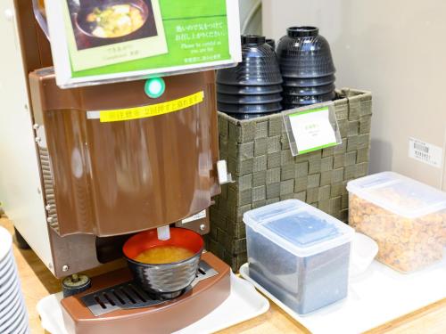 a coffee maker is on display in a store at Hotel Econo Fukui Station in Fukui
