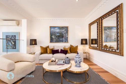 uma sala de estar com um sofá e uma mesa em Annandale Sydney 2 Storey Cottage + Courtyard em Sydney