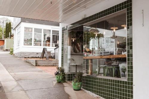 a store front with green tile on the side of a building at Apt with Aircon & Loft Bedroom Great Location in Devonport