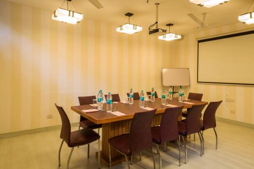 a conference room with a long table and chairs at Home@F37 Kailash Colony Metro in New Delhi
