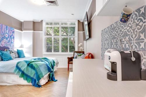 a bedroom with a bed and a sewing machine in it at Cozy Studio in Adina Brisbane CBD Anzac Square in Brisbane