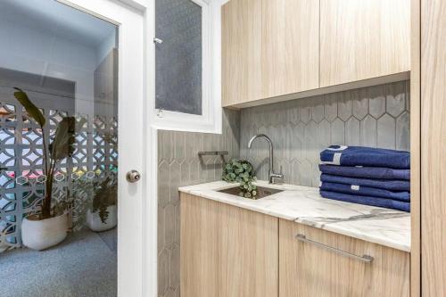 a kitchen with a sink and a counter top at Gold Coast-Miami Mid-Century Beach Home With Pool in Gold Coast
