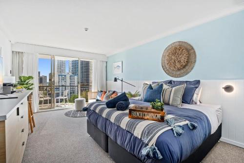 a bedroom with a large bed with a large window at Mantra View Studio Surfers Paradise Walk To Beach in Gold Coast