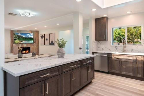 a large kitchen with a large white counter top at Luxurious 4-Bedroom Home with Pool & Jacuzzi! in Los Angeles