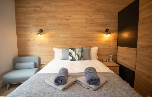 a bedroom with a bed with towels on it at Aqua nest Eastbourne in Eastbourne