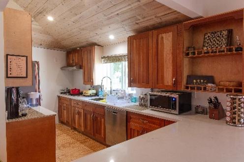 a kitchen with wooden cabinets and a counter top at Roomi in Los Angeles