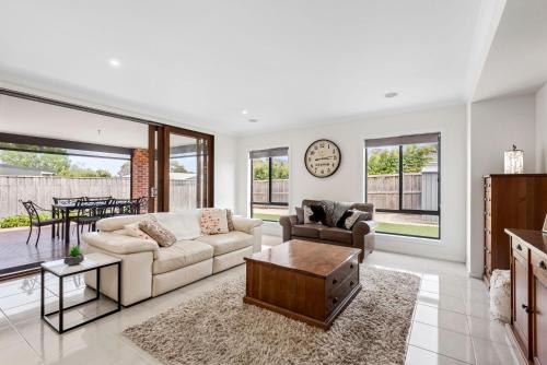 a living room with a couch and a table at Getaway on the Rise in Portarlington