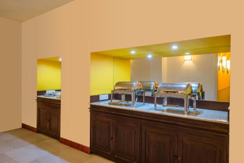 a restaurant with a counter with a queue of food at Home@F37 Kailash Colony Metro in New Delhi