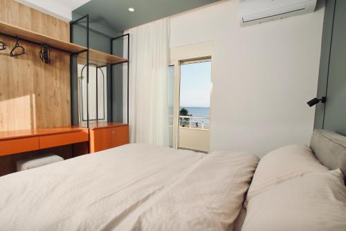 a bedroom with a bed and a view of the ocean at Luxurious Dreamy seaview apartment in Durrës