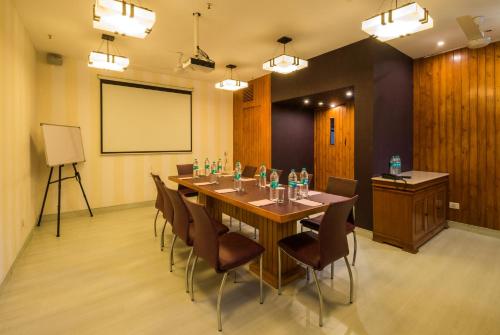 a conference room with a long table and chairs at Home@F37 Kailash Colony Metro in New Delhi