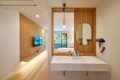 a bathroom with a sink and a mirror at LUXE TECH VILLA Ashitoku - Vacation STAY 10822v in Akaoki
