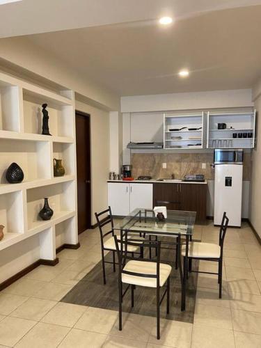 a dining room with a table and chairs in a kitchen at Departamento Oaxaca Bella in Oaxaca City