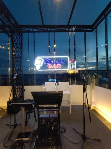 a room with a table and a sign on the window at Hotel Harmony In & Karaoke in Pontianak