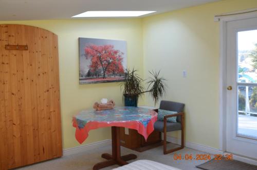 a table with a teddy bear on it in a room at Estuary House Reflexology B&B in Courtenay