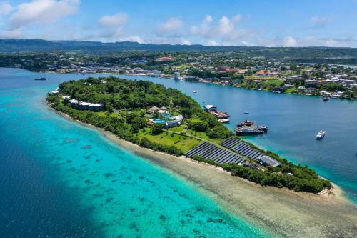 an island with a solar farm in the water at Iririki Island Resort & Spa in Port Vila