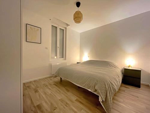 une chambre blanche avec un lit et une fenêtre dans l'établissement Charmant T2 rénové à Berck Plage, proche mer et centre, idéal pour séjour sur la côte d'Opale - FR-1-646-61, à Berck-sur-Mer