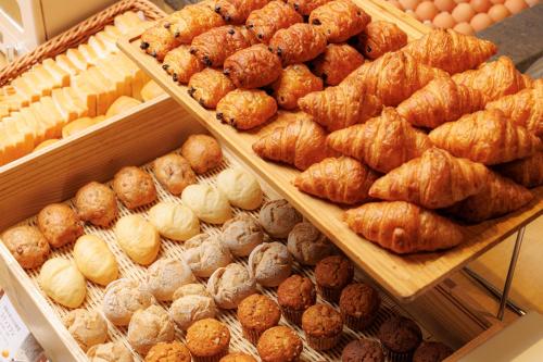 a display of breads and pastries in a bakery at JR Kyushu Hotel Blossom Shinjuku in Tokyo